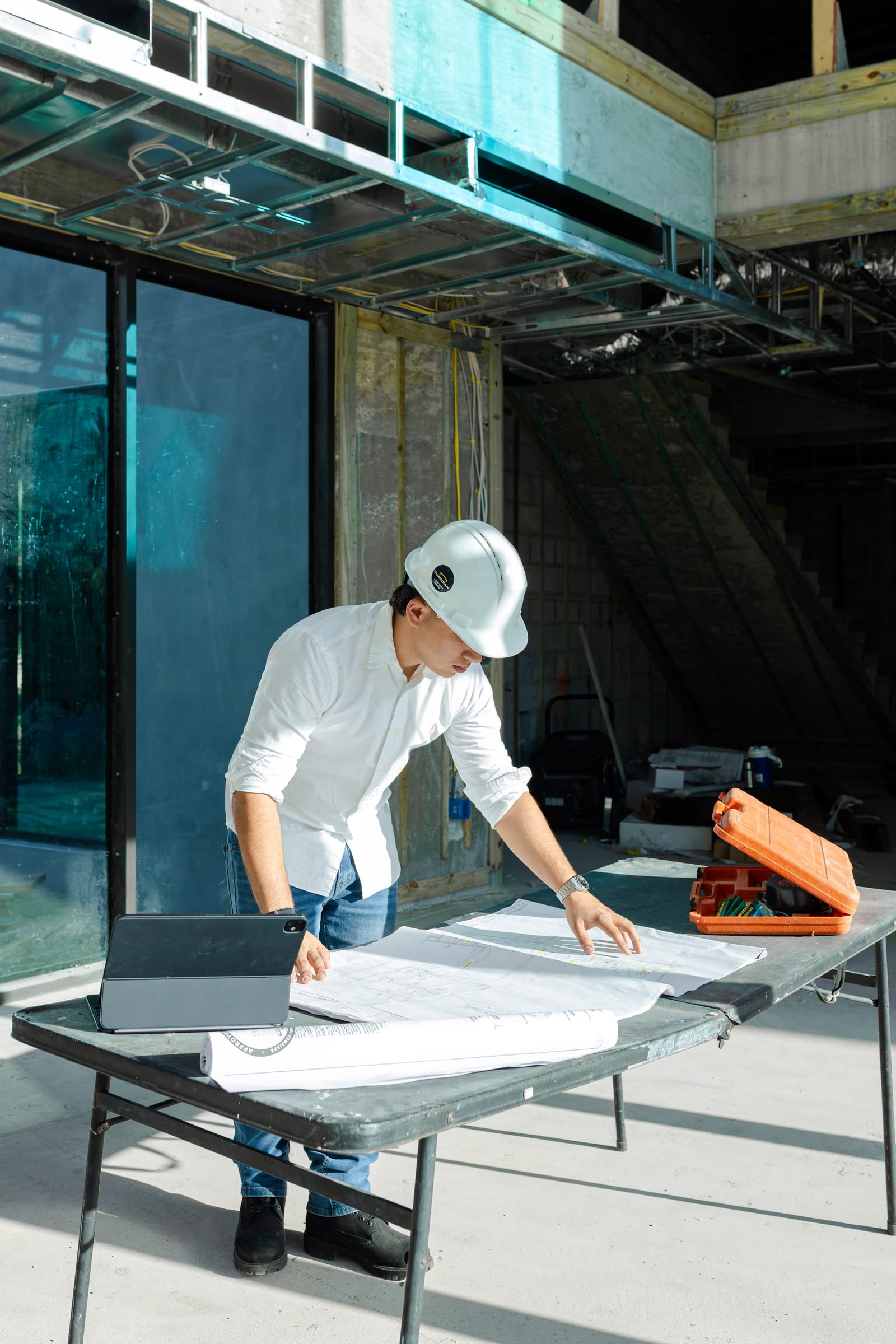 Contractor supervising interior structural metal framing and ceiling systems